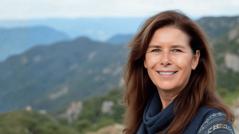 Helena Demuynck smiling outdoors, embodying leadership with authenticity, supporting women executives to lead with inner clarity and confidence.