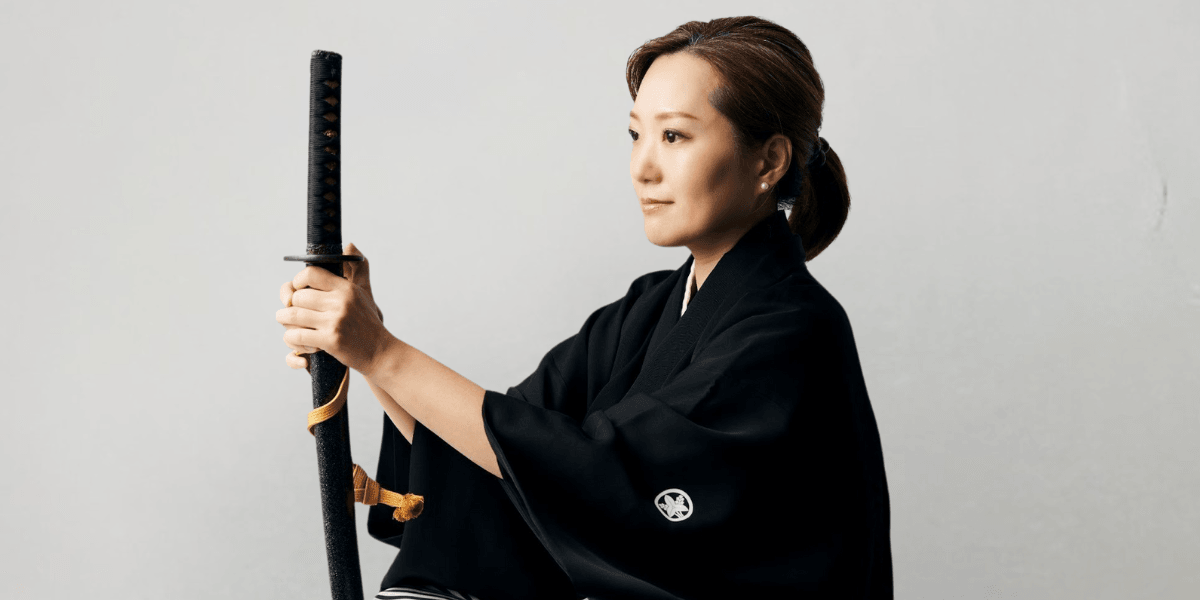 Woman in traditional kimono holding a katana, symbolizing samurai discipline and mental focus.