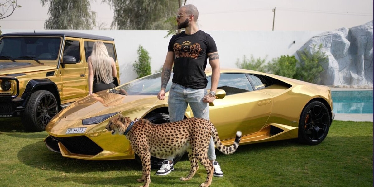 Damianos Prosalentis standing confidently with a golden Lamborghini and a cheetah, symbolizing luxury and success.