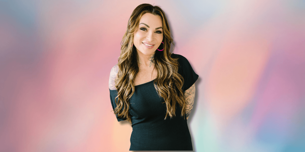 Image of a woman with long hair wearing a black dress, smiling at the camera against a pastel-colored background with the text "Empowering Women Through Data" next to her.
