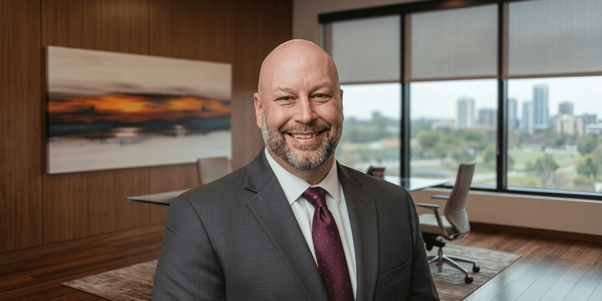 Smiling business executive in a modern boardroom with city skyline visible through large office windows.