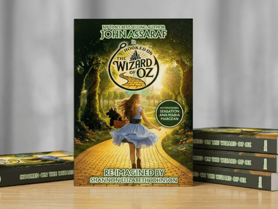 A book titled "Hooked on the Wizard of Oz" by John Assaraf on a table.