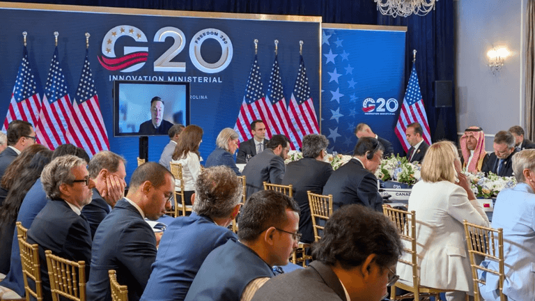 G20 Innovation Ministerial meeting with delegates and flags in a conference setting