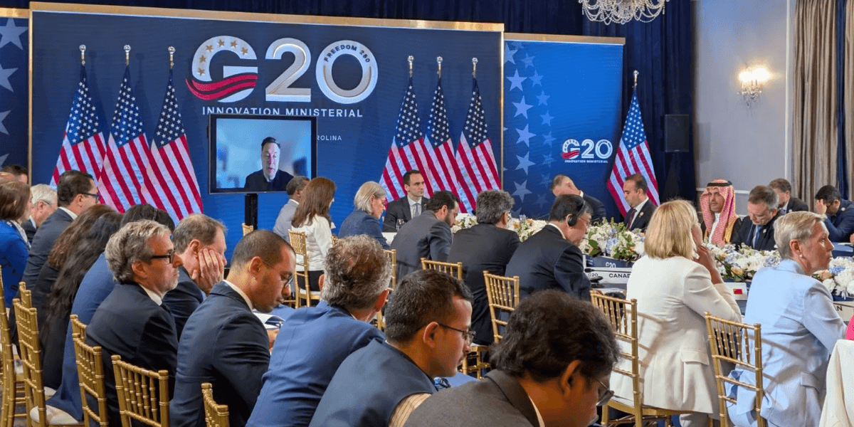 G20 Innovation Ministerial meeting with delegates and flags in a conference setting
