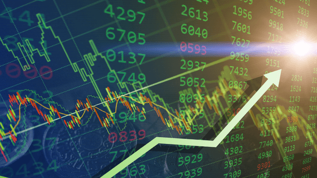Financial chart with rising trend lines and stock prices on a digital display