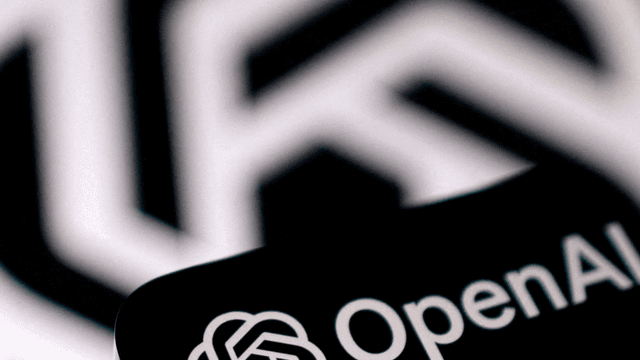 Close-up of the OpenAI logo with a blurred geometric background