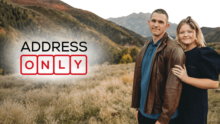 A couple stands together in a scenic mountain landscape with text overlay "ADDRESS ONLY"