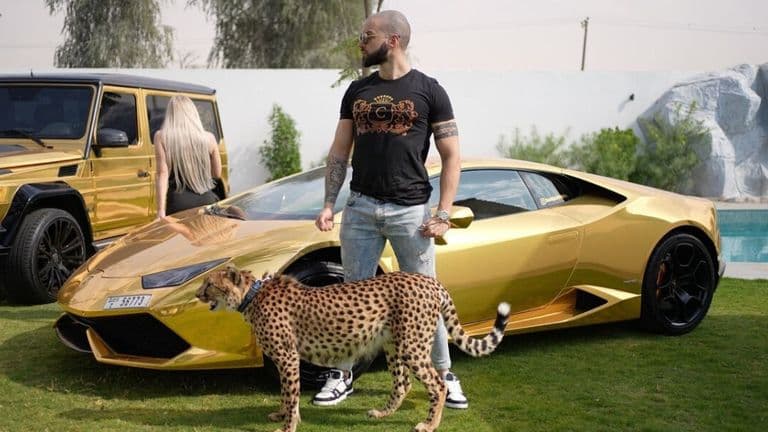 Damianos Prosalentis standing confidently with a golden Lamborghini and a cheetah, symbolizing luxury and success.