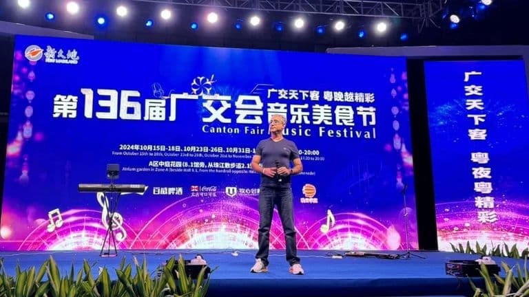 Speaker at the 136th Canton Fair Music Festival, showcasing the stage with event details and audience backdrop.