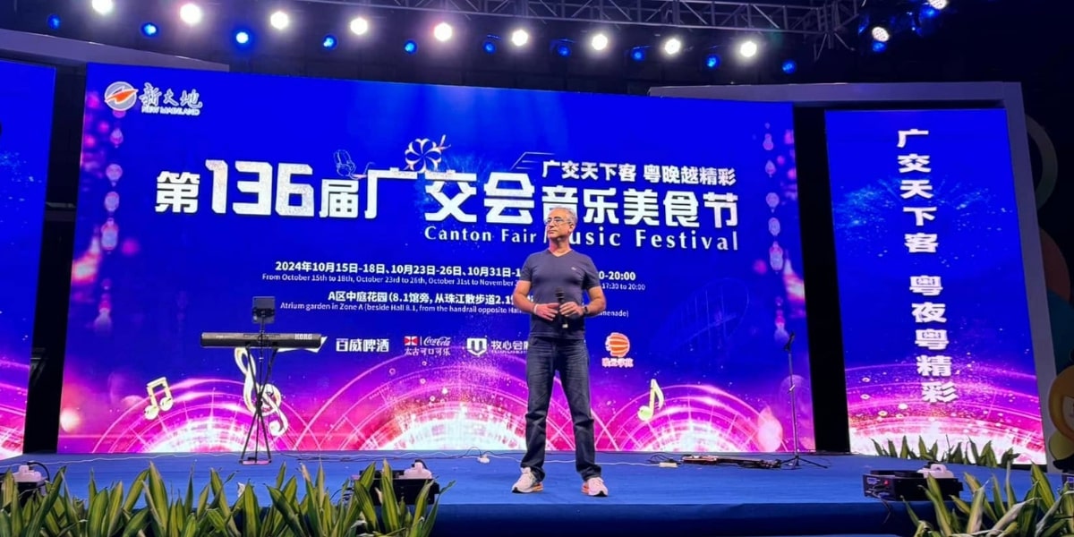 Speaker at the 136th Canton Fair Music Festival, showcasing the stage with event details and audience backdrop.