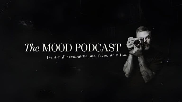 A black-and-white image of a man holding a camera, with 'The MOOD Podcast' title and tagline about creative conversations.