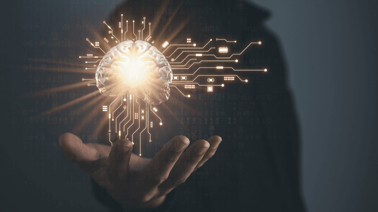 A hand holding a glowing brain connected to digital circuits, symbolizing artificial intelligence and advanced technology.