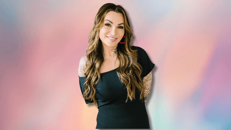 Image of a woman with long hair wearing a black dress, smiling at the camera against a pastel-colored background with the text "Empowering Women Through Data" next to her.